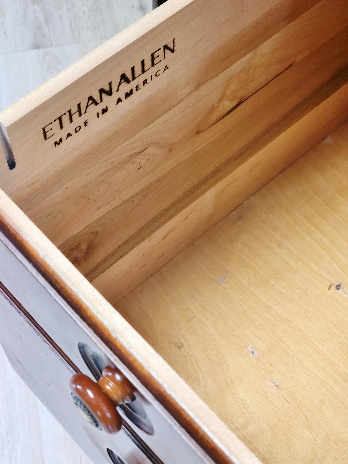 Wooden drawer with 'Ethan Allen' branding and 'Made in America' text.