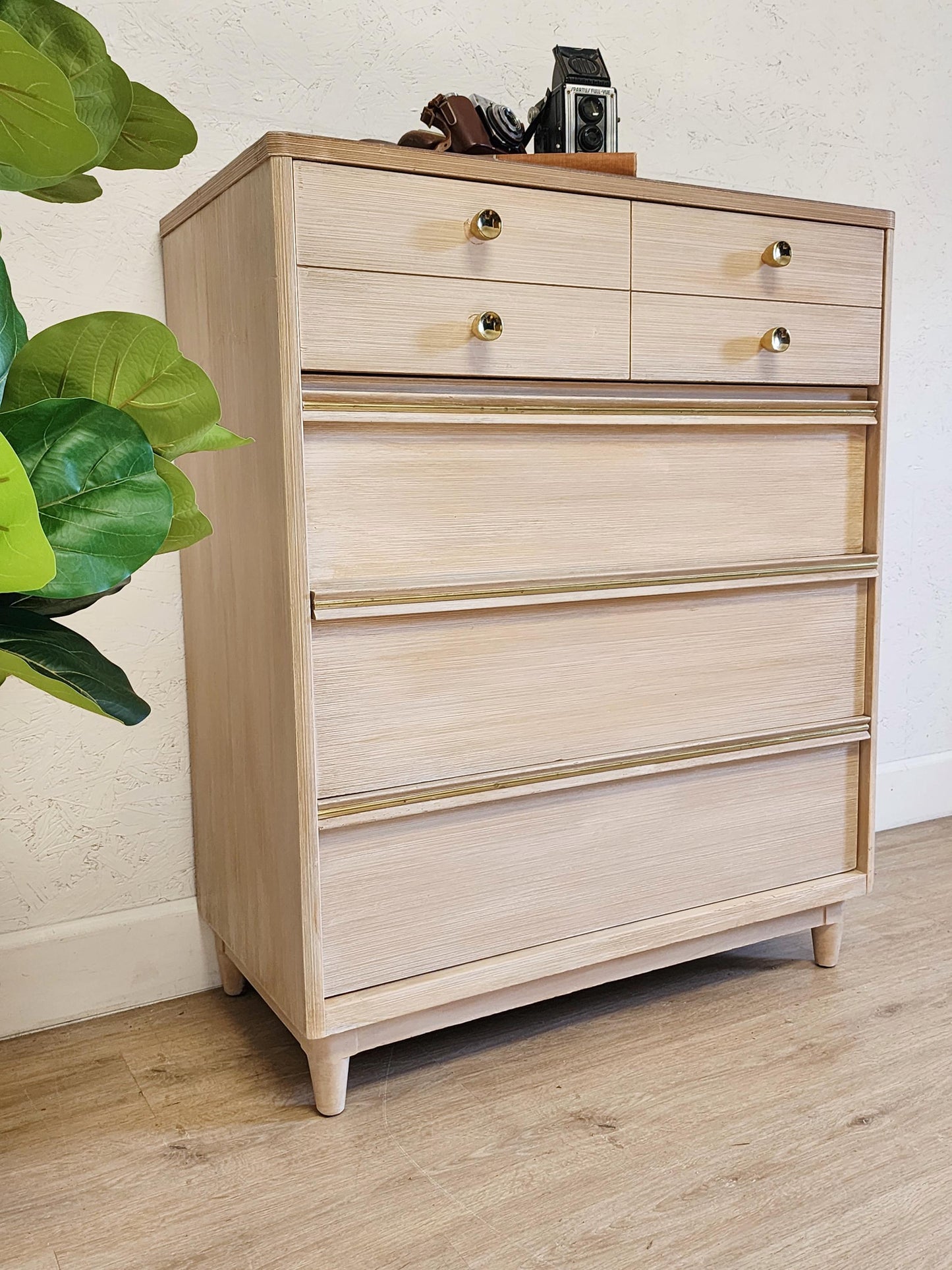 blonde mcm tall chest with gold pulls 