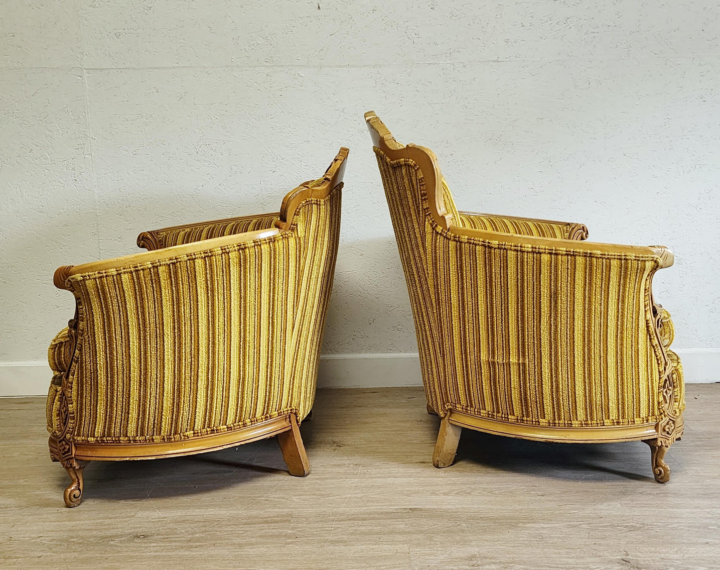 side view of antique carved armchairs